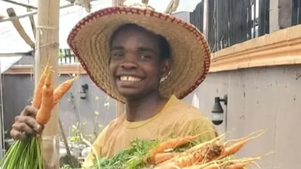 K.A.I. trainee holding a carrot harvest